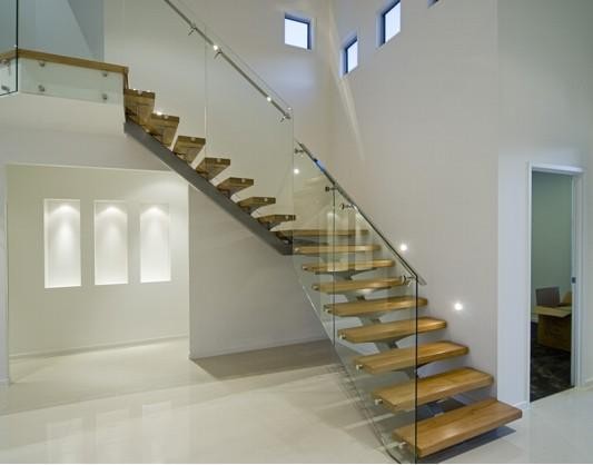 Single spine stairs with glass railing 